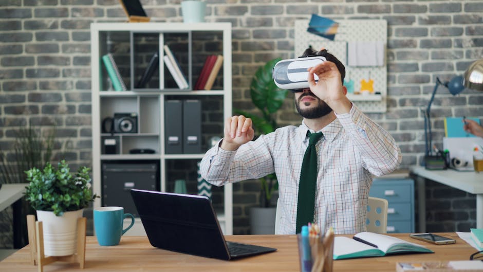 Man wearing VR headset explores virtual reality at desk in modern office setting.