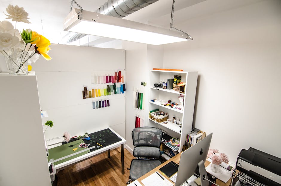 Elegant and organized creative workspace featuring design materials and office equipment, perfect for innovative work.